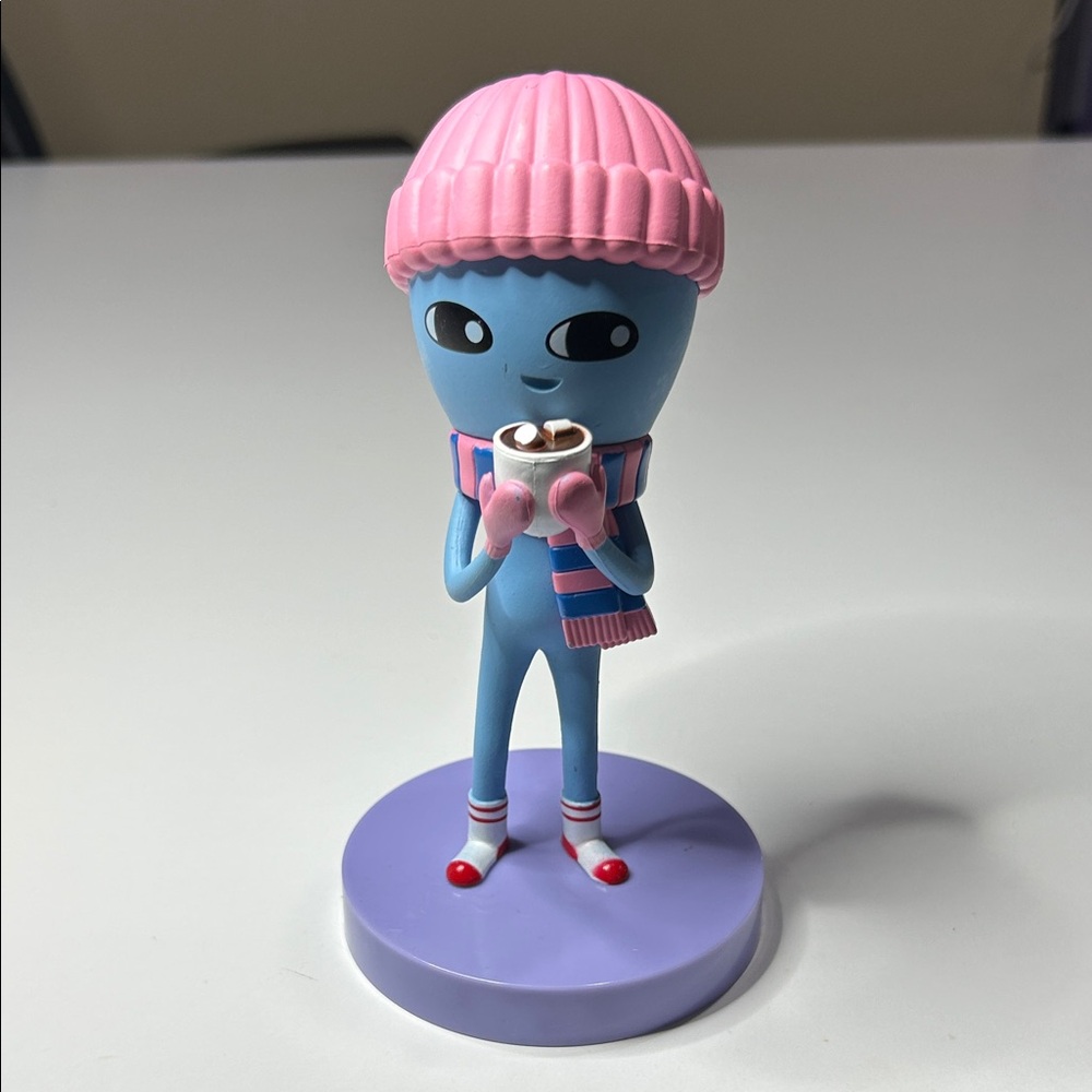 Nathan W. Pyle’s Strange Planet being with hot cocoa.